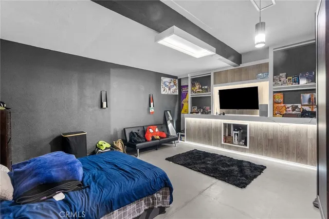 a bedroom with furniture and a flat screen tv