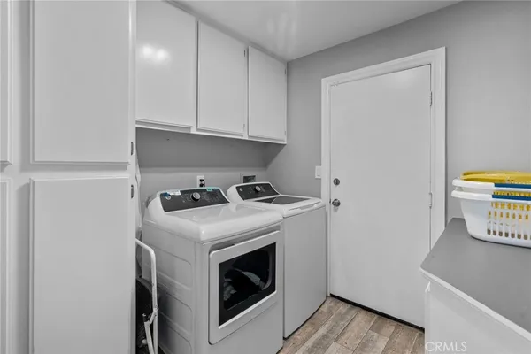 a view of washer and dryer with kitchen in the background