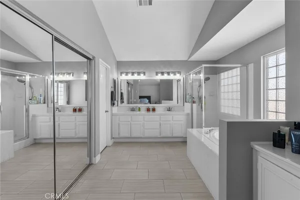 a large white bathroom with a tub a shower and sink