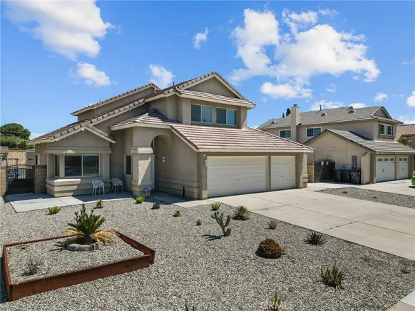 a front view of house with yard outdoor seating and barbeque oven