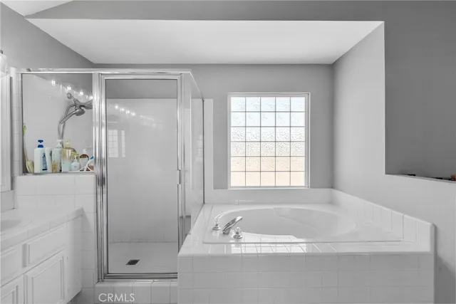 a bathroom with a tub shower and sink