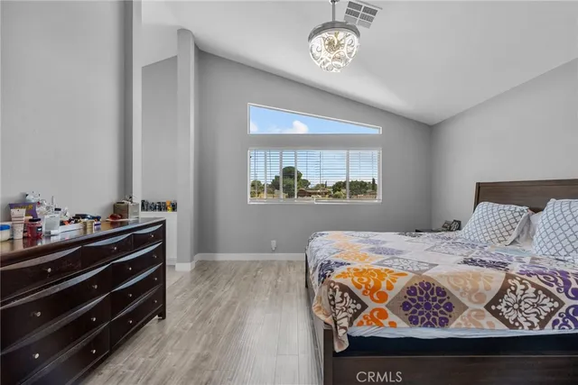 a bed sitting in a bedroom next to a window