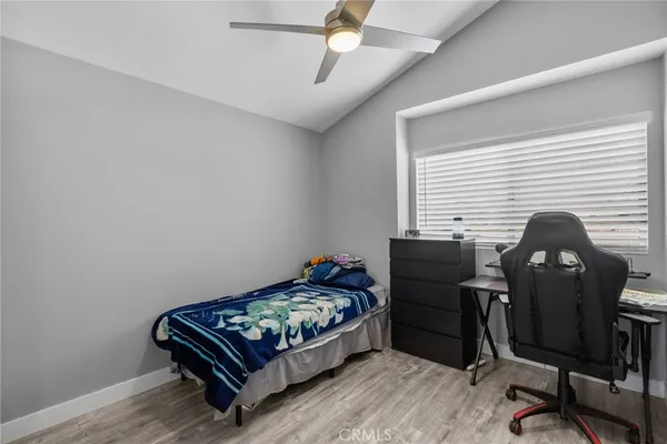 a bedroom with a bed and a desk