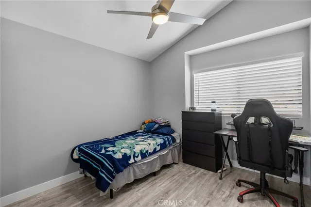 a bedroom with a bed and a desk