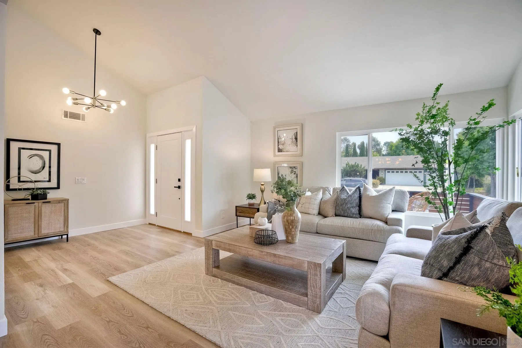 3577 Winslow Road Oceanside, CA 92056 - Photo 11 of 42 a living room with furniture and a chandelier