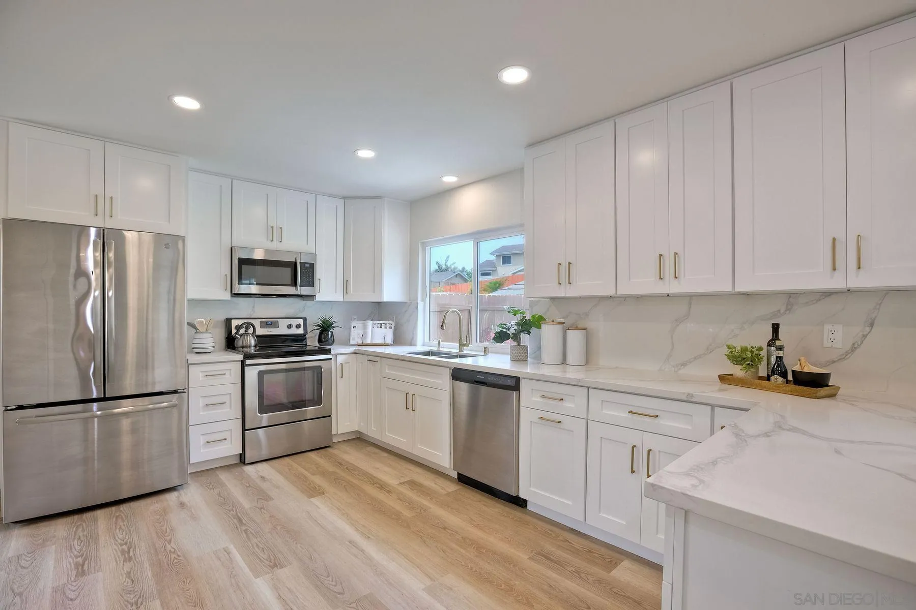 3577 Winslow Road Oceanside, CA 92056 - Photo 13 of 42 a kitchen with white cabinets stainless steel appliances and a refrigerator