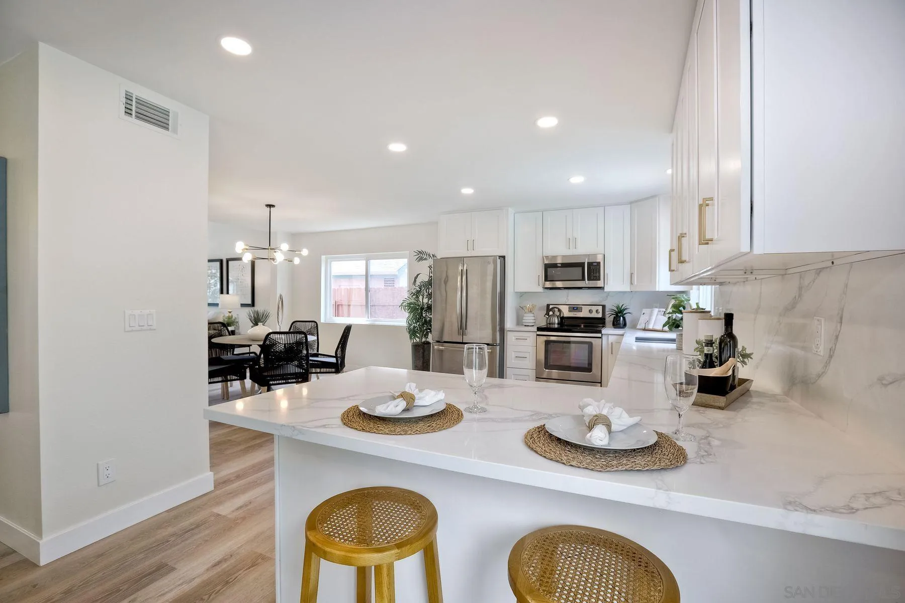 3577 Winslow Road Oceanside, CA 92056 - Photo 14 of 42 a kitchen with sink refrigerator dining table and chairs