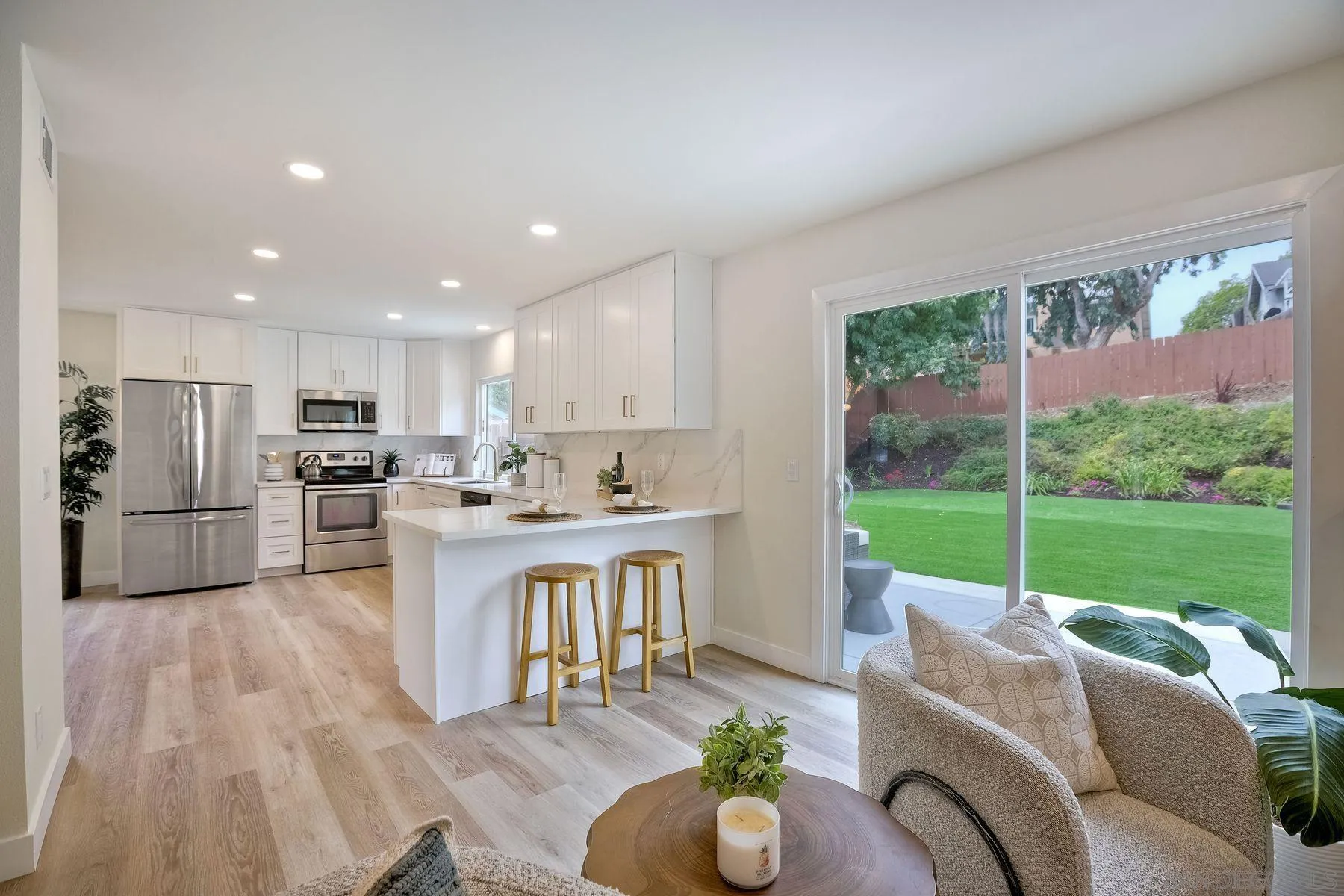 3577 Winslow Road Oceanside, CA 92056 - Photo 15 of 42 a open kitchen with stainless steel appliances granite countertop a refrigerator sink and white cabinets with wooden floor