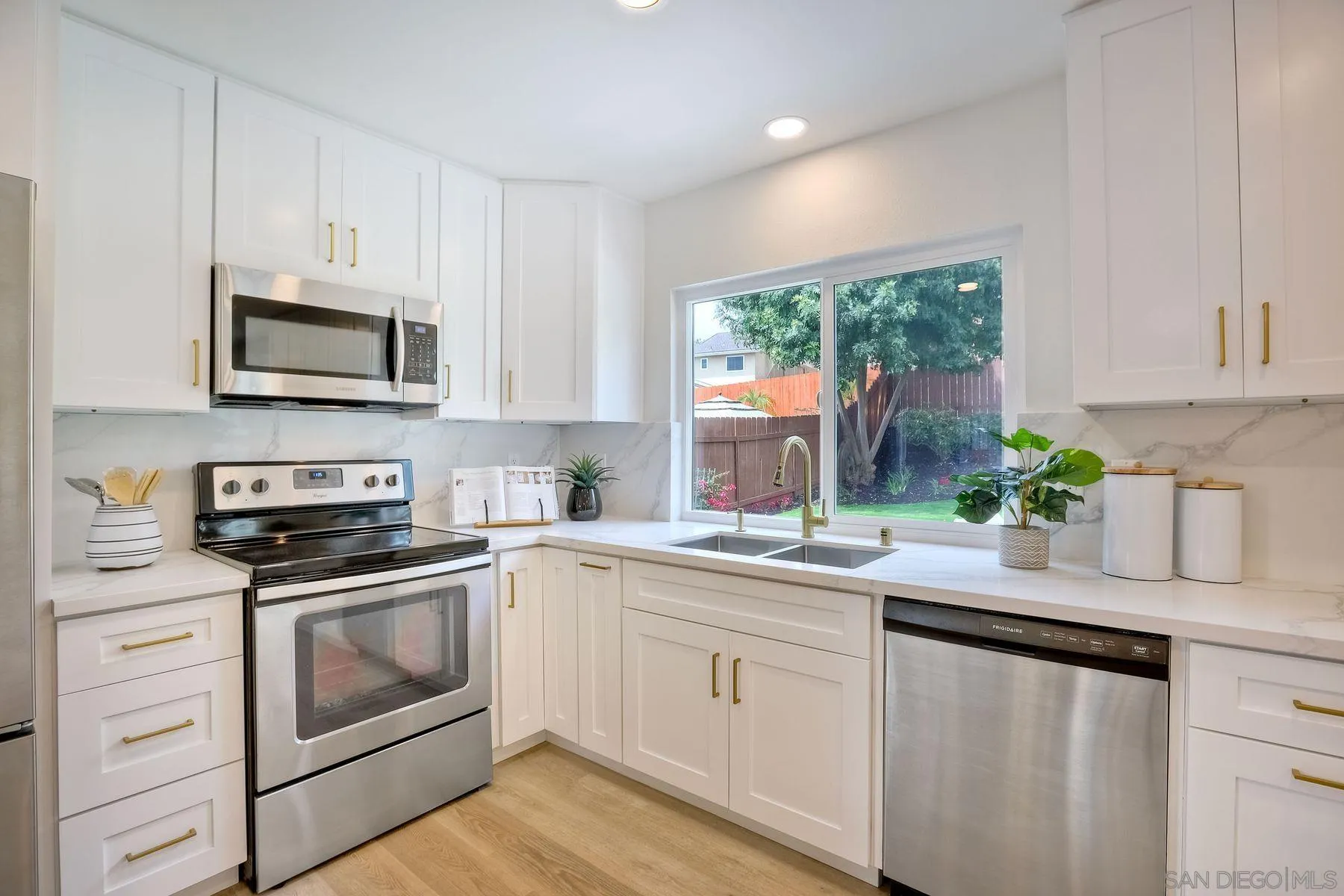 3577 Winslow Road Oceanside, CA 92056 - Photo 17 of 42 a kitchen with white cabinets stainless steel appliances and a sink
