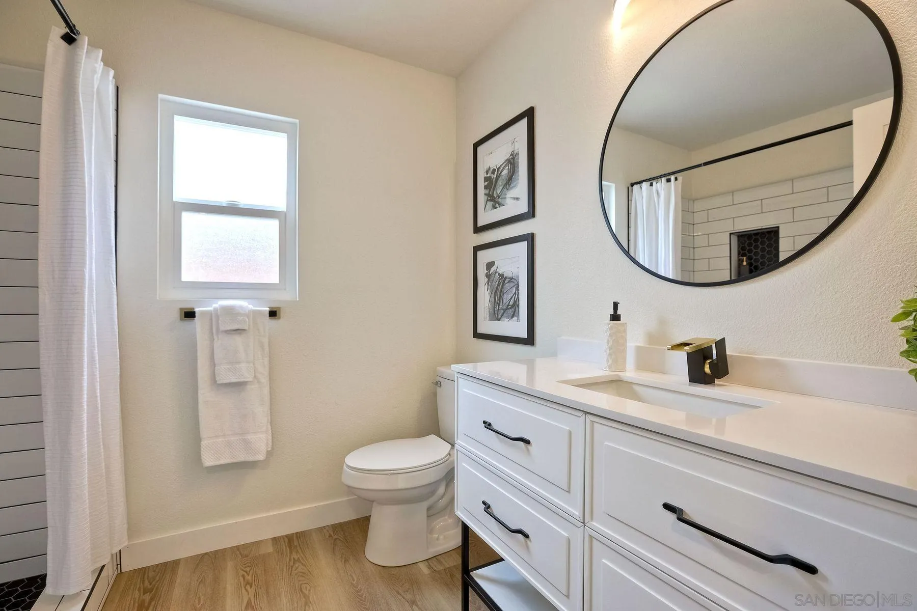 3577 Winslow Road Oceanside, CA 92056 - Photo 23 of 42 a bathroom with a toilet a sink a mirror and vanity