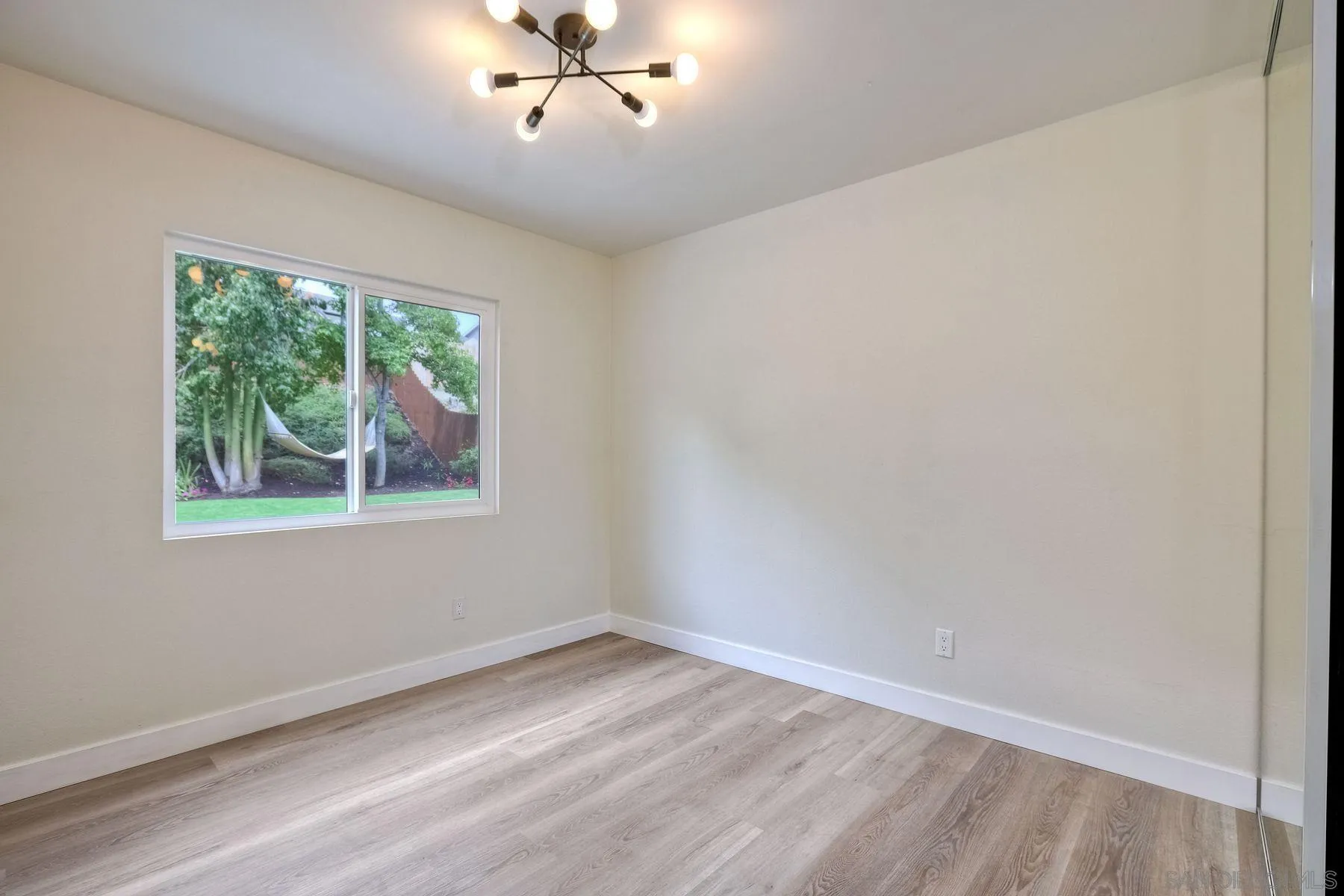 3577 Winslow Road Oceanside, CA 92056 - Photo 25 of 42 a view of empty room with wooden floor and fan