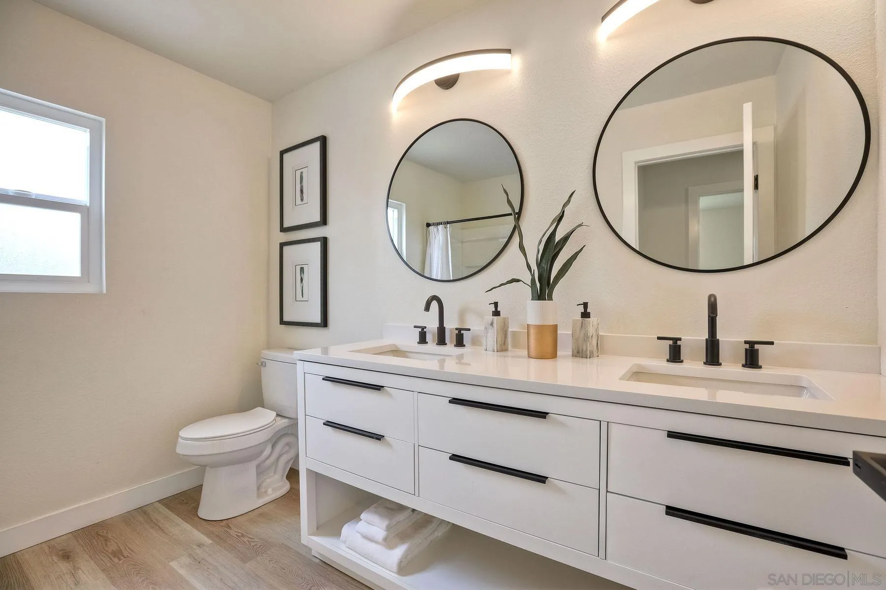 3577 Winslow Road Oceanside, CA 92056 - Photo 33 of 42 a bathroom with a toilet a sink and a mirror
