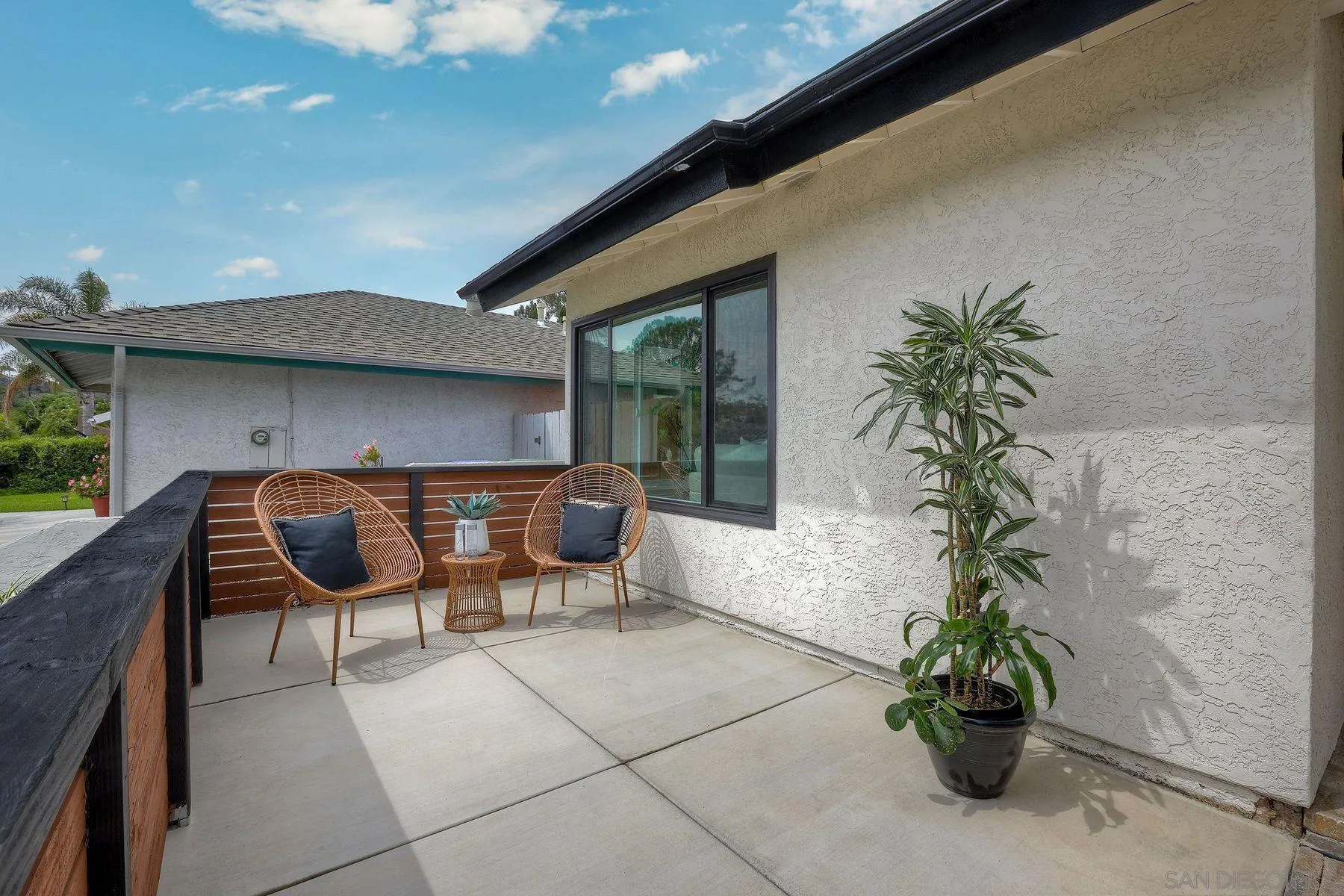 3577 Winslow Road Oceanside, CA 92056 - Photo 8 of 42 a balcony with table and chairs potted plants with wooden fence