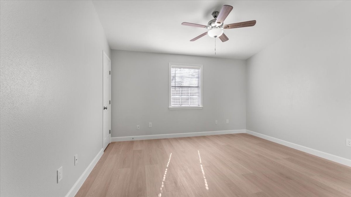 3123 Patience Avenue Houston, TX 77014 - Photo 15 of 22 wooden floor in an empty room with a window