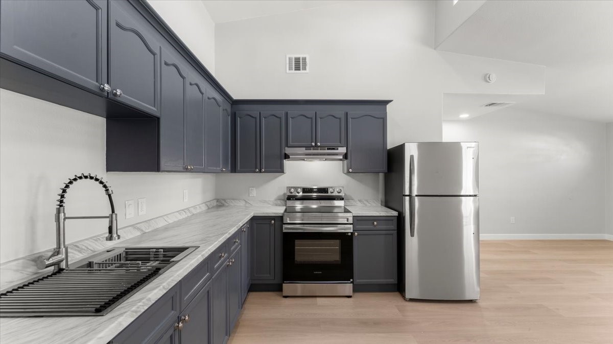3123 Patience Avenue Houston, TX 77014 - Photo 8 of 22 a kitchen with stainless steel appliances granite countertop a stove a refrigerator and a sink