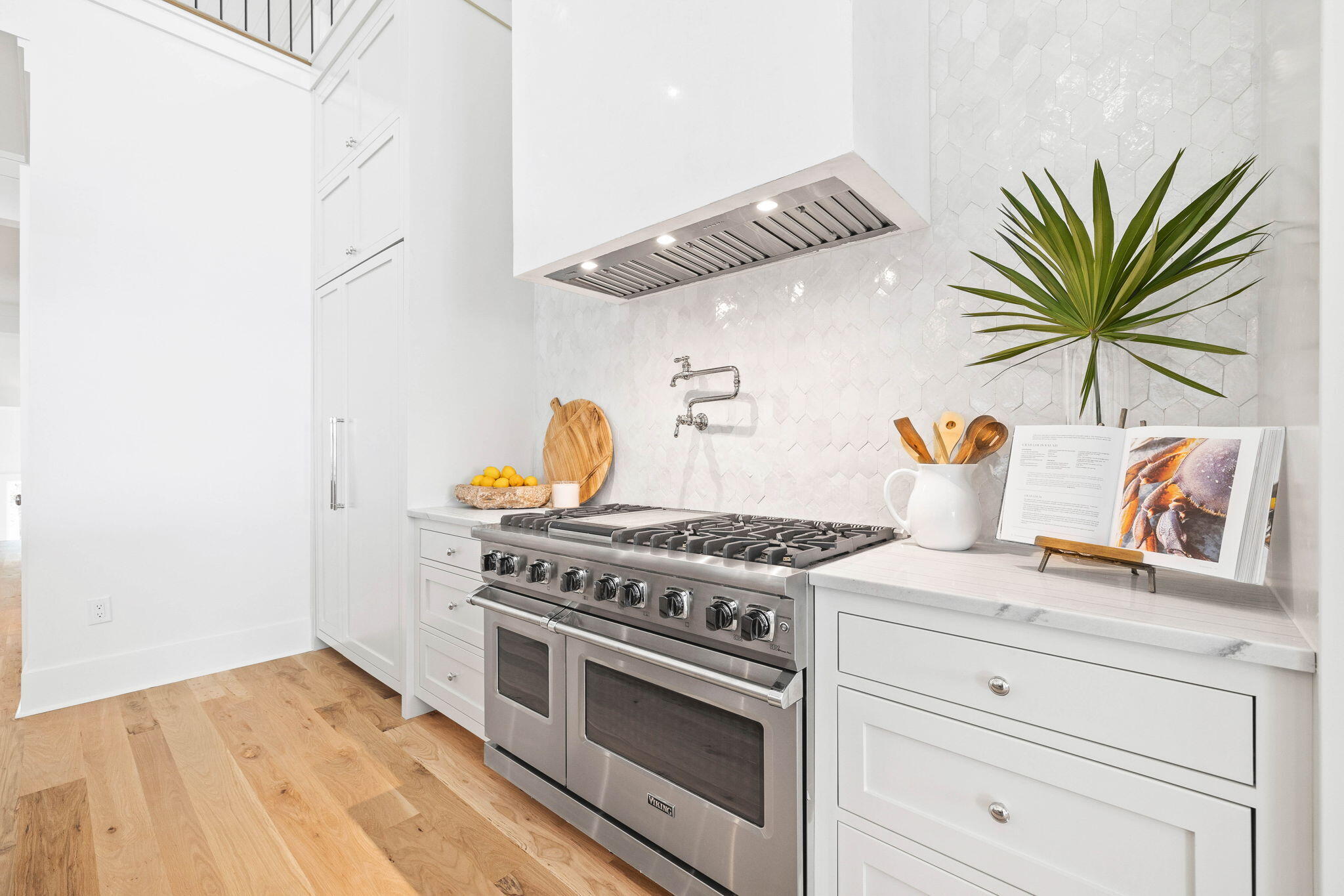 357 Old Beach Road Santa Rosa Beach, FL 32459 - Photo 13 of 106 a kitchen with a stove and a white wooden cabinets