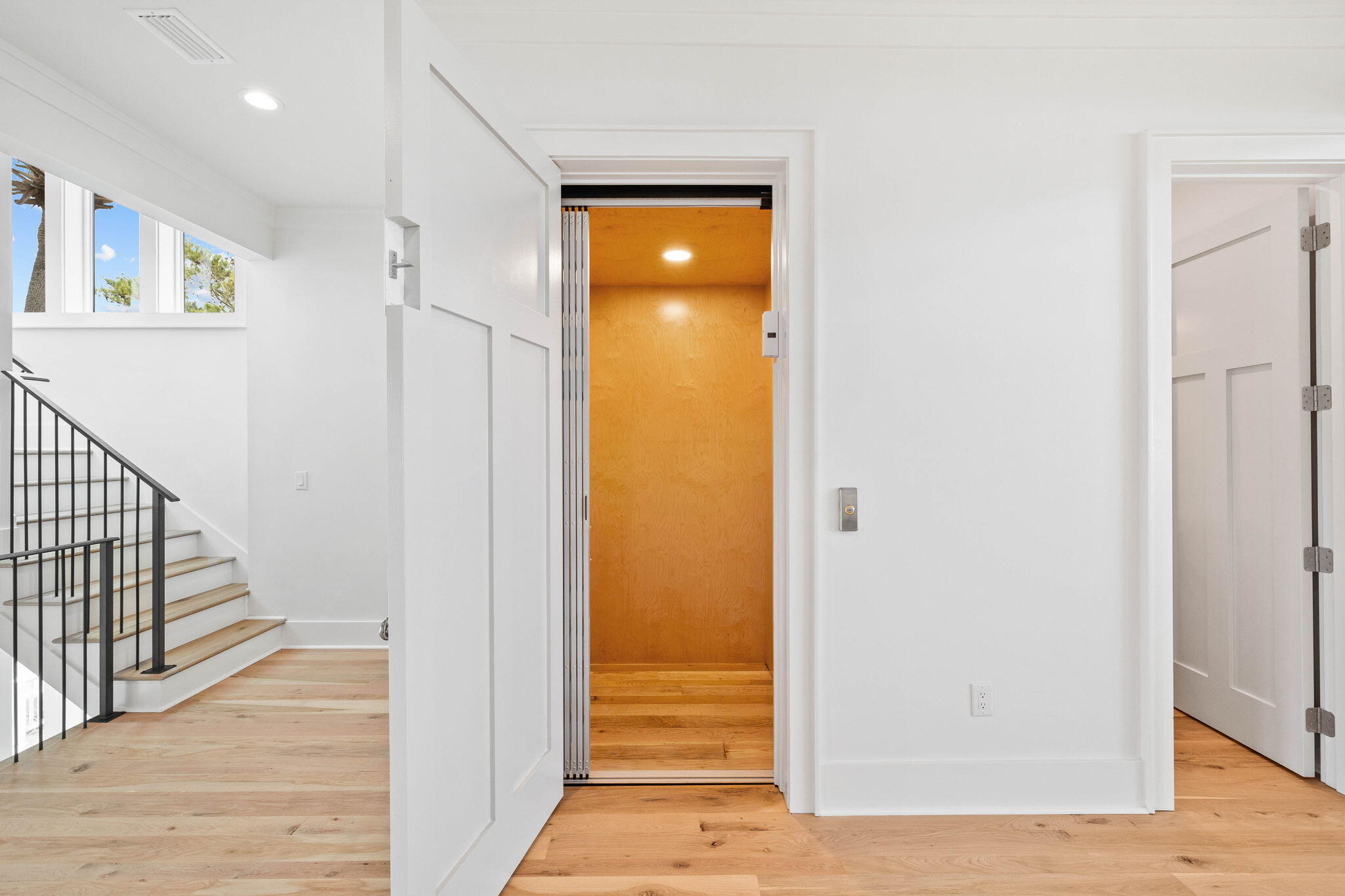 357 Old Beach Road Santa Rosa Beach, FL 32459 - Photo 31 of 106 a view of a hallway with wooden floor and cabinet with a living room