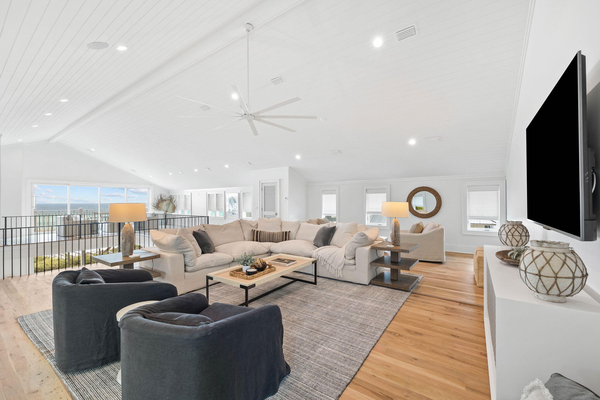 357 Old Beach Road Santa Rosa Beach, FL 32459 - Photo 40 of 106 a living room with furniture a rug and a flat screen tv