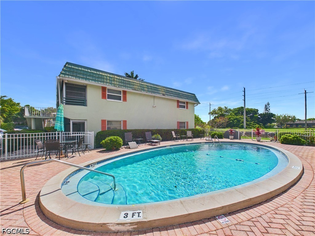 300 Valley Stream Drive, Unit 3D Naples, FL 34113 - Photo 20 of 21 a view of swimming pool with outdoor seating
