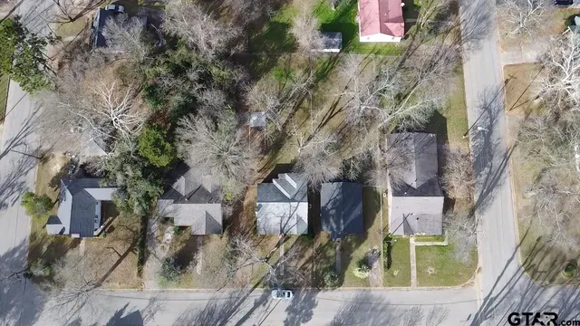 an aerial view of residential houses with outdoor space