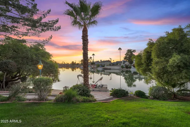 a large bed sitting in a bedroom next to a window