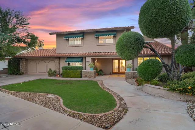 a large white kitchen with a large window
