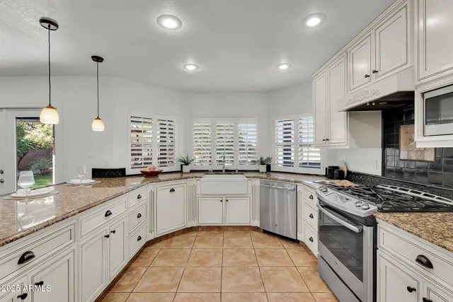 a bathroom with a granite countertop sink a mirror and a toilet
