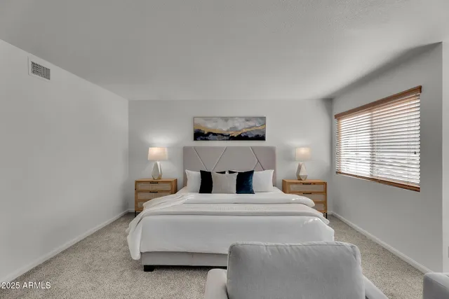 a view of a lake with a table and chairs