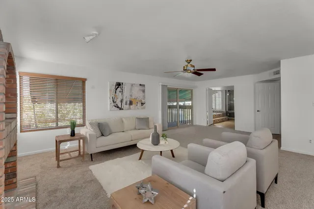 a view of a swimming pool with a yard and potted plants
