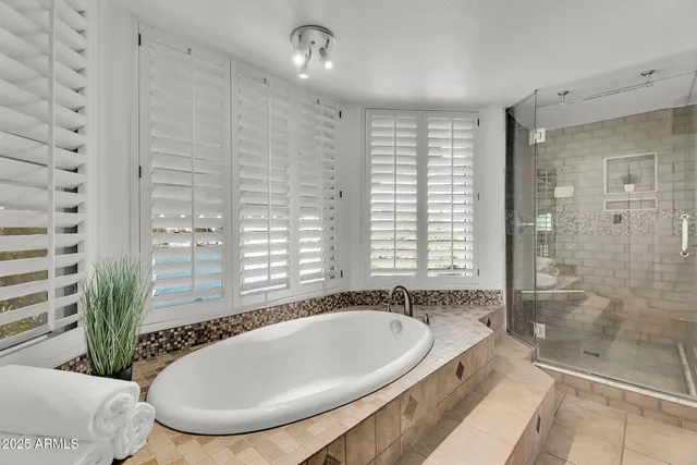 a view of a house with a yard and potted plants