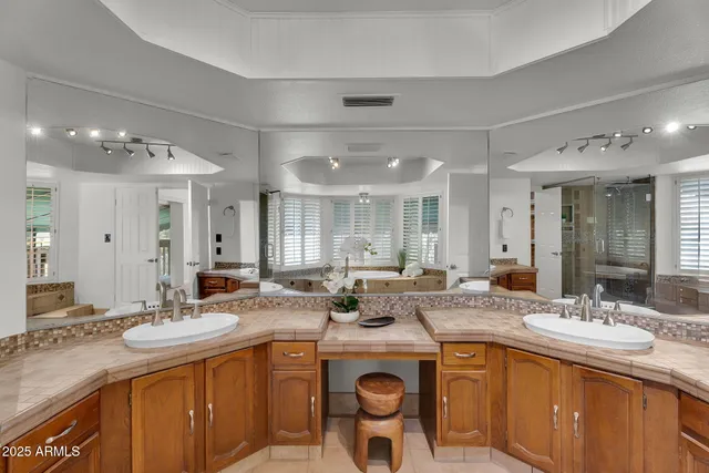 an aerial view of a house with a yard lake lake and mountain view in back