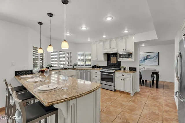 a living room with furniture a potted plant and a table