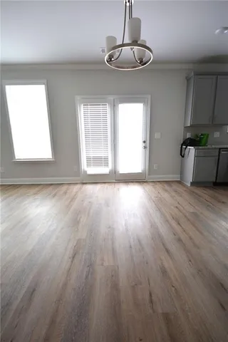 a kitchen with granite countertop white cabinets and stainless steel appliances