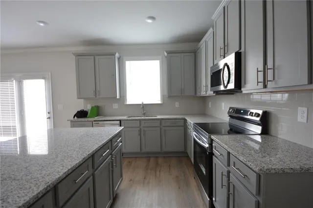 an empty room with a ceiling fan and window