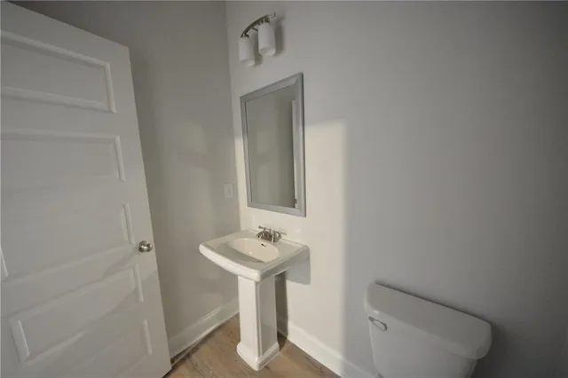 a view of a kitchen with a sink and a refrigerator