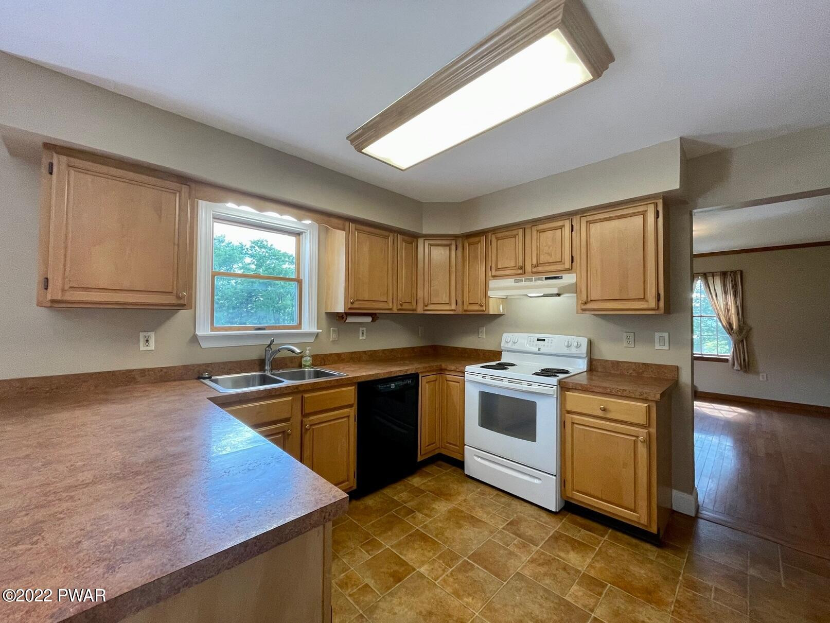 524 Creamton Drive Prompton, PA 18456 - Photo 13 of 57 a kitchen with stainless steel appliances granite countertop a stove a sink and a microwave