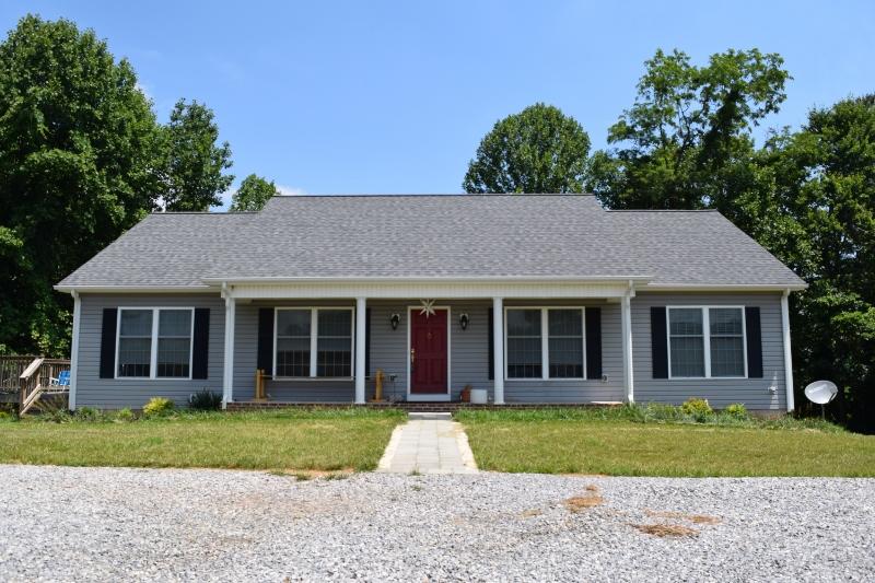 923 Long Level Road Southwest Floyd, VA 24091 - Photo 1 of 33 a view of a brick house with a large windows and large trees