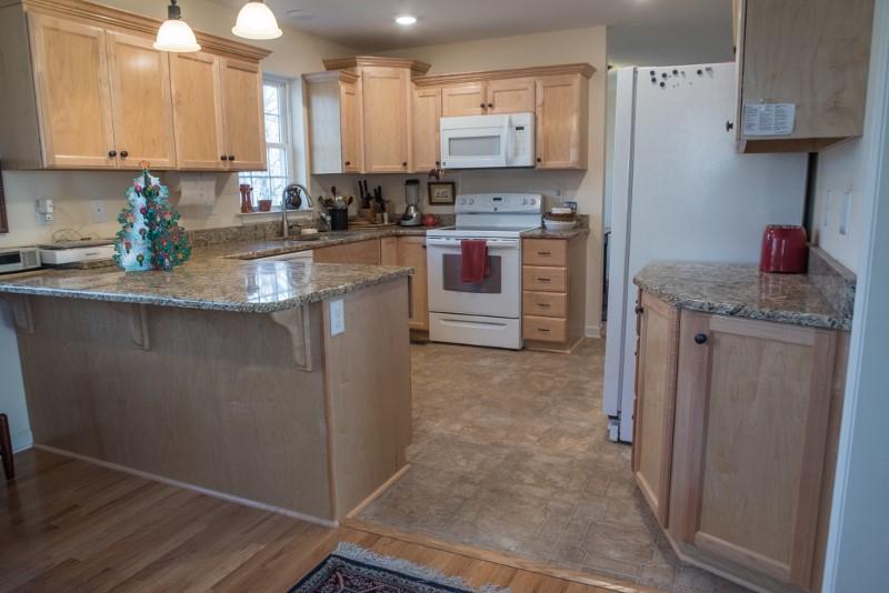 923 Long Level Road Southwest Floyd, VA 24091 - Photo 23 of 33 a kitchen with stainless steel appliances granite countertop a sink stove and refrigerator