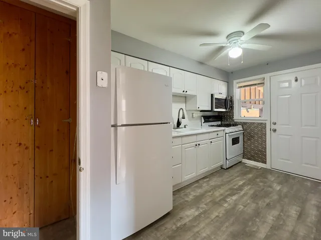 a kitchen with a refrigerator a sink and cabinets
