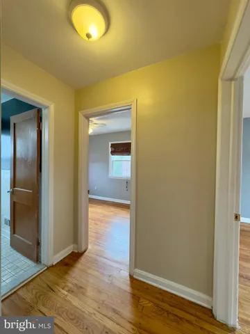 an empty room with wooden floor and closet
