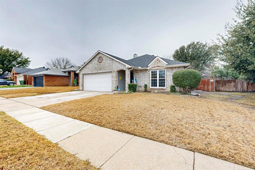 Ranch-style house with a garage and a front yard