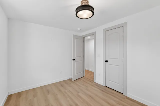 a view of a room with wooden floor