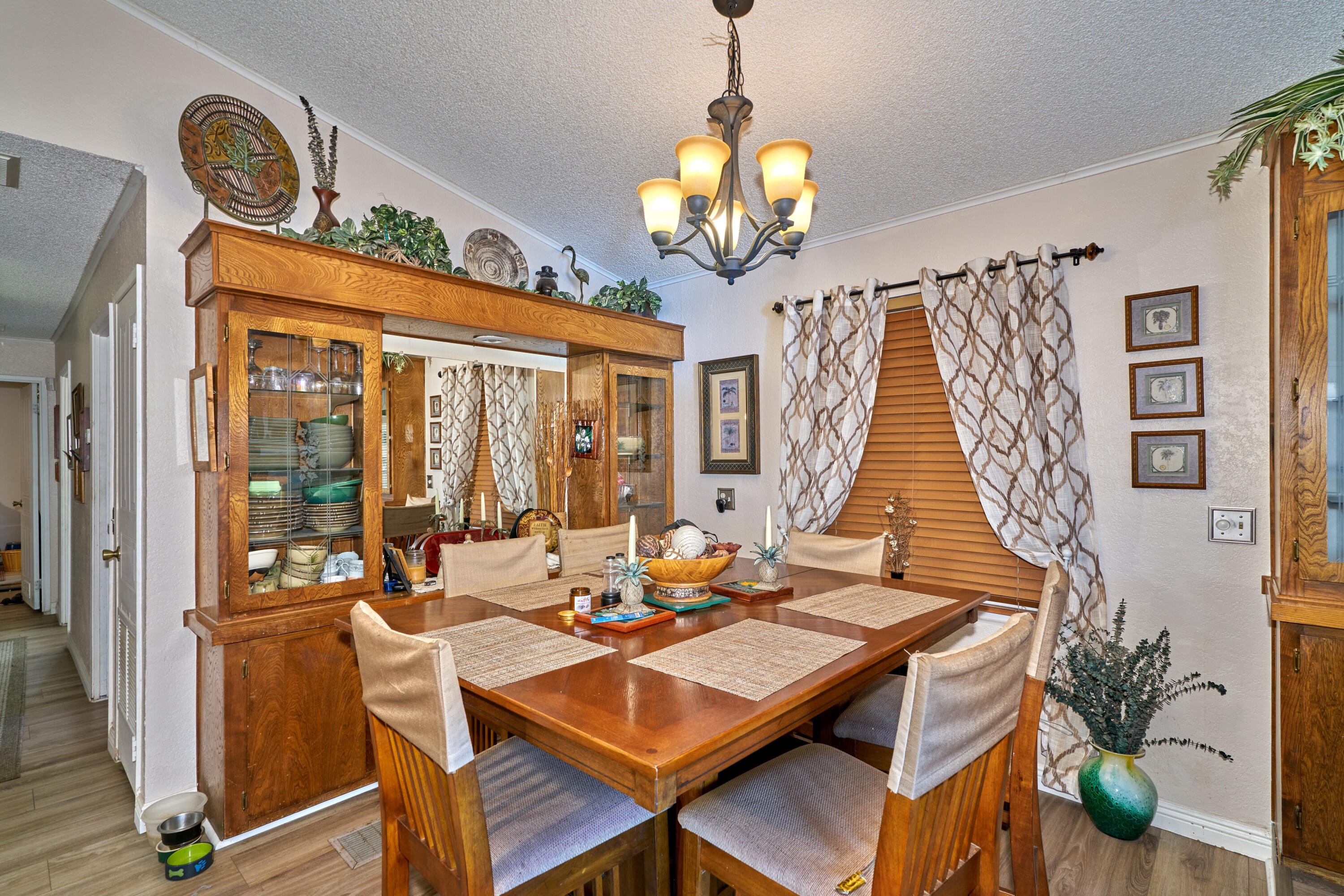 33537 Lisa Circle Thousand Palms, CA 92276 - Photo 7 of 35 a view of a dining room with furniture wooden floor and chandelier