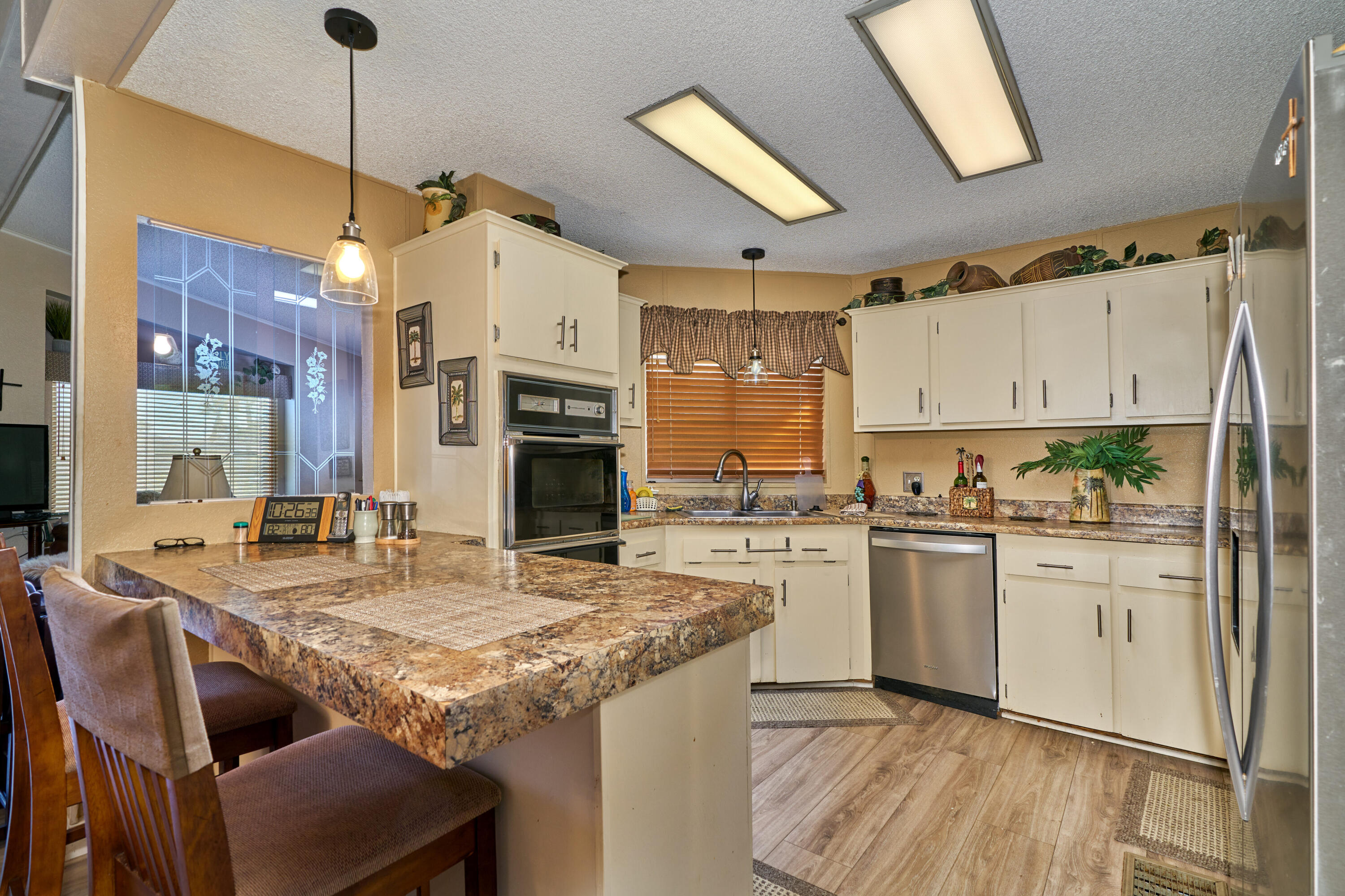 33537 Lisa Circle Thousand Palms, CA 92276 - Photo 9 of 35 a kitchen with kitchen island granite countertop a sink cabinets and stainless steel appliances