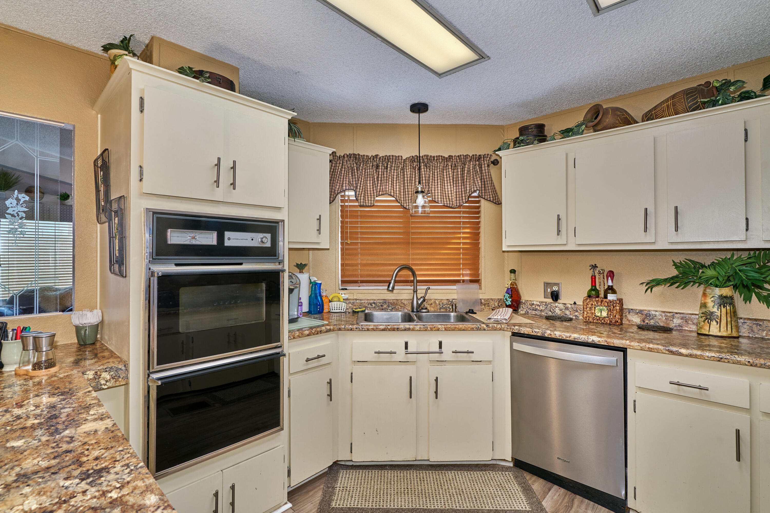 33537 Lisa Circle Thousand Palms, CA 92276 - Photo 10 of 35 a kitchen with white cabinets stainless steel appliances and sink