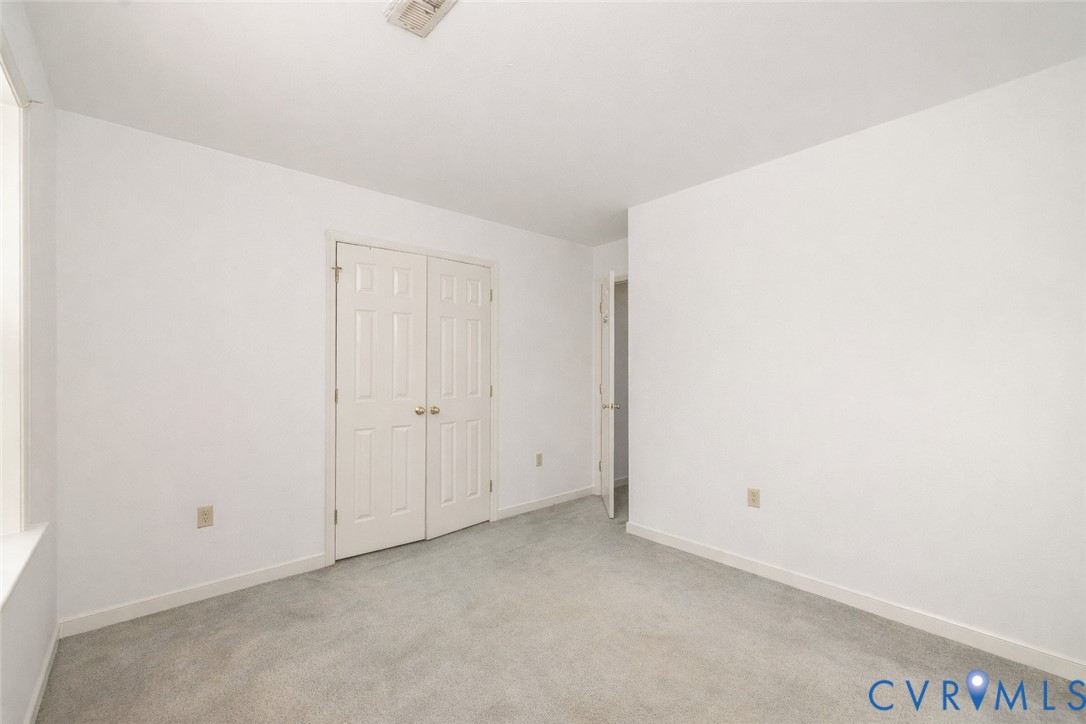 10 Rhodes Lane Cartersville, VA 23027 - Photo 14 of 16 Unfurnished bedroom with carpet flooring and a clo