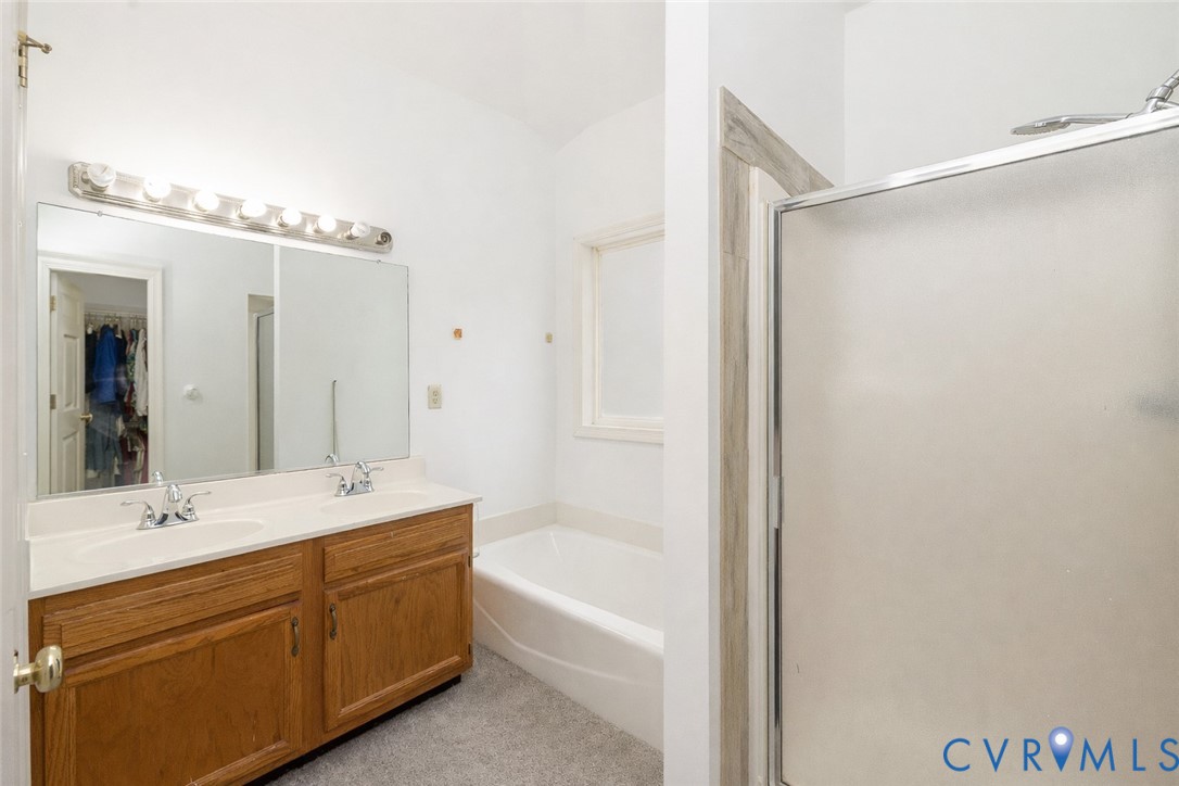 10 Rhodes Lane Cartersville, VA 23027 - Photo 16 of 16 Bathroom featuring double vanity, a garden tub, a