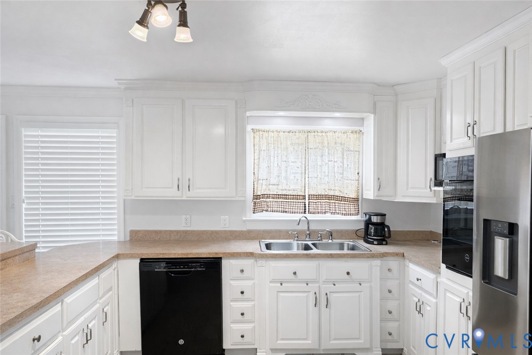 10 Rhodes Lane Cartersville, VA 23027 - Photo 3 of 16 Kitchen with black appliances, white cabinets, and