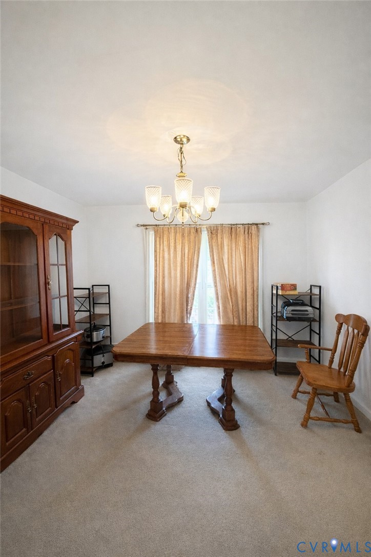 10 Rhodes Lane Cartersville, VA 23027 - Photo 8 of 16 Dining area with light carpet and hanging lights