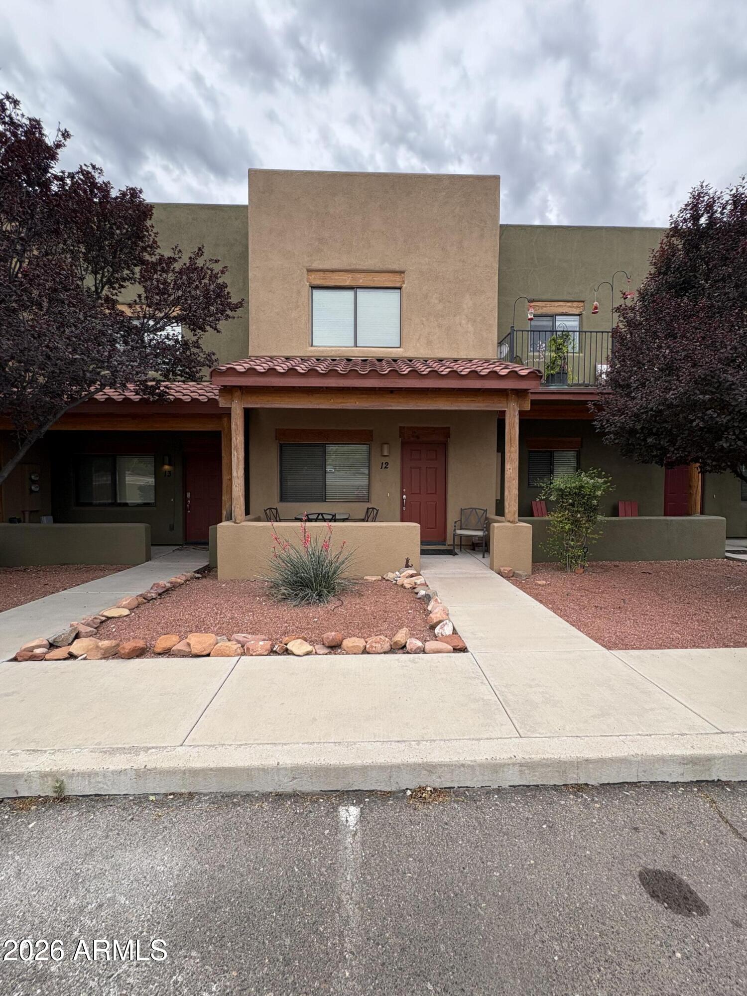 a front view of a house with a garden